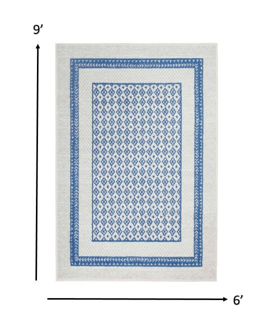 4’ X 6’ Ivory And Blue Geometric Area Rug