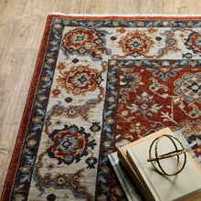 6' X 9' Red Blue Ivory Gold And Navy Oriental Power Loom Stain Resistant Area Rug With Fringe