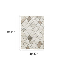 3' X 5' Beige Grey Tan And Brown Geometric Power Loom Stain Resistant Area Rug