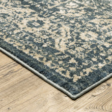 5' X 7' Beige Grey And Blue Oriental Power Loom Stain Resistant Area Rug