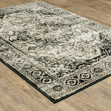 5' X 7' Black Grey Tan And Ivory Oriental Power Loom Stain Resistant Area Rug