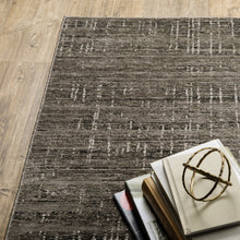 6' X 9' Charcoal Grey Grey Ivory Tan And Brown Abstract Power Loom Stain Resistant Area Rug