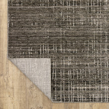 6' X 9' Charcoal Grey Grey Ivory Tan And Brown Abstract Power Loom Stain Resistant Area Rug
