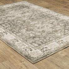5' X 7' Grey Ivory Tan And Beige Oriental Power Loom Stain Resistant Area Rug