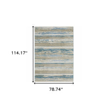 6' X 9' Ivory Beige Grey Blue And Tan Abstract Power Loom Stain Resistant Area Rug With Fringe