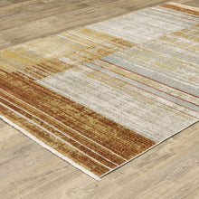 8' X 11' Rust Gold Blue Grey Ivory And Tan Geometric Power Loom Stain Resistant Area Rug With Fringe