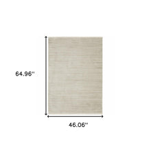 4' X 6' Ivory Beige Taupe And Tan Geometric Power Loom Stain Resistant Area Rug With Fringe