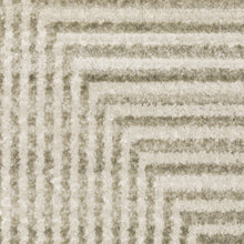 5' X 8' Ivory Beige Taupe And Tan Geometric Power Loom Stain Resistant Area Rug With Fringe