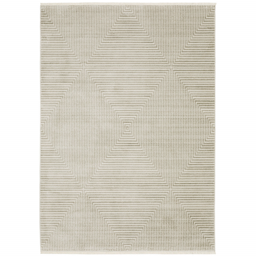 6' X 9' Ivory Beige Taupe And Tan Geometric Power Loom Stain Resistant Area Rug With Fringe