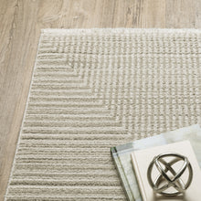 6' X 9' Ivory Beige Taupe And Tan Geometric Power Loom Stain Resistant Area Rug With Fringe