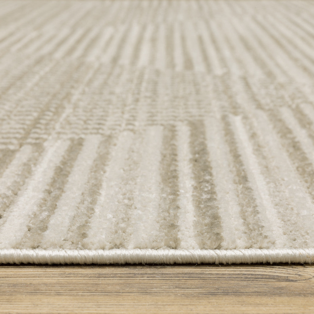 6' X 9' Ivory Beige Taupe And Tan Geometric Power Loom Stain Resistant Area Rug With Fringe