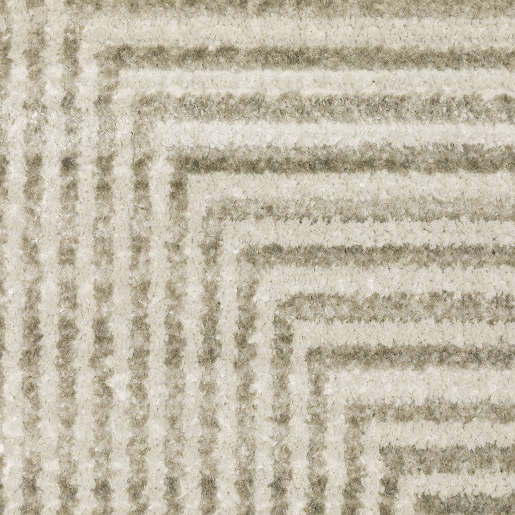 8' X 11' Ivory Beige Taupe And Tan Geometric Power Loom Stain Resistant Area Rug With Fringe