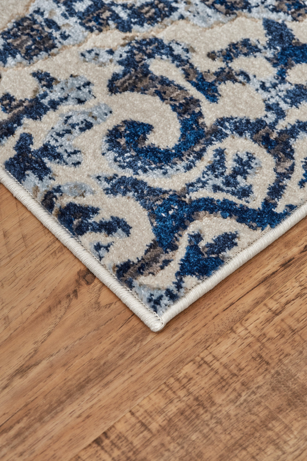 Blue Ivory And Black Floral Distressed Stain Resistant Area Rug - 2' X 4'