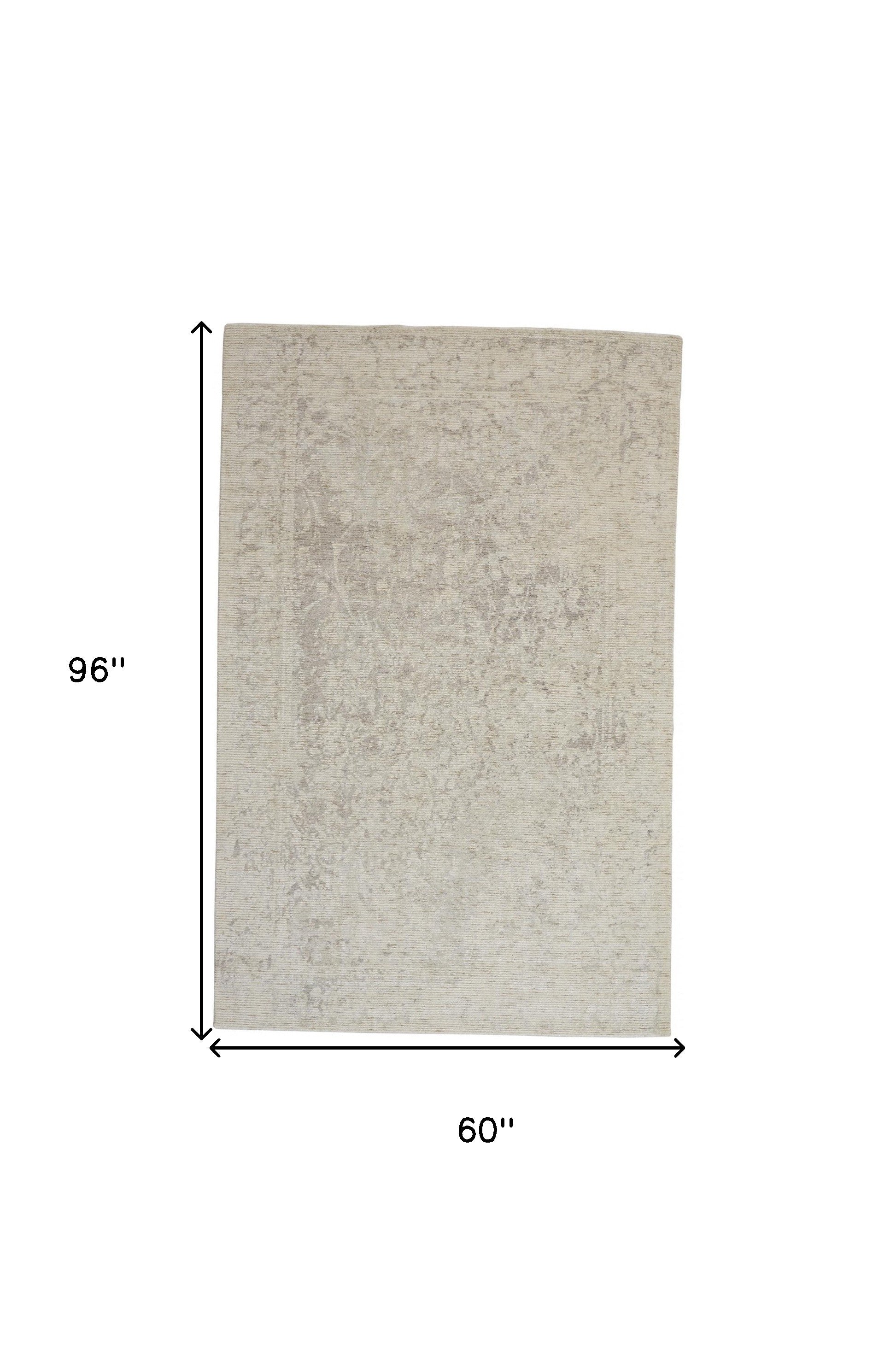 5' X 8' Ivory And Tan Abstract Hand Woven Area Rug