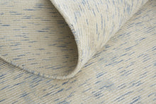 5' X 8' Ivory And Tan Abstract Hand Woven Area Rug