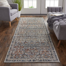 5' X 8' Tan Blue And Orange Floral Power Loom Distressed Area Rug With Fringe