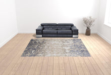 4' X 6' Tan Ivory And Blue Abstract Power Loom Distressed Area Rug